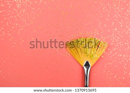 Paint brush with sparkles on living coral background. Trendy color of the year 2019.