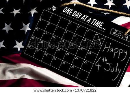 Overhead picture of calendar on united states flag, indicating the date 4th July 2019 in the calendar