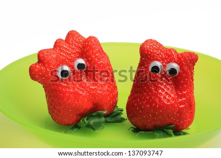 two funny strawberry characters with jiggle eyes
