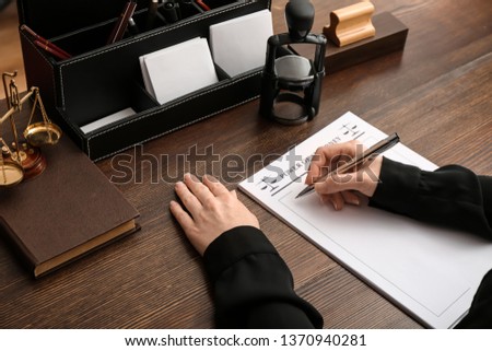 Female notary public working at table