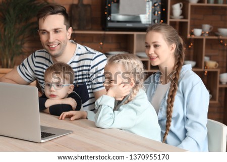 Happy family watching cartoons at home