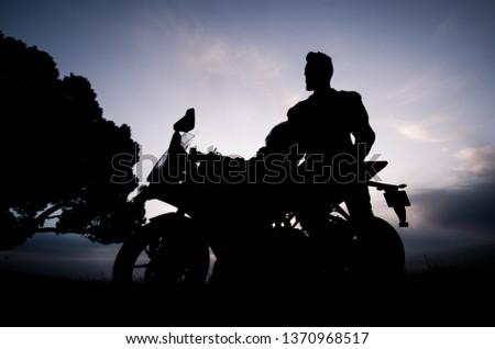 Biker with his Bike Silhouette at Sunset