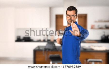 Painter man making stop gesture denying a situation that thinks wrong at home