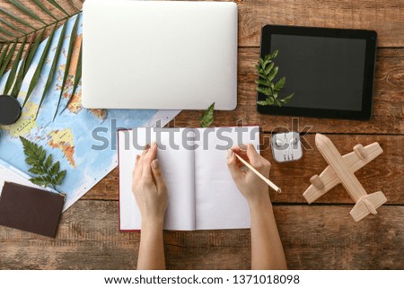 Travel agent working at wooden table