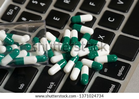 A notebook keyboard and some pills