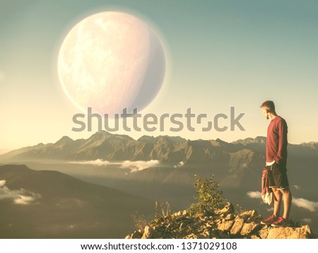 traveling young man and huge planet in the sky