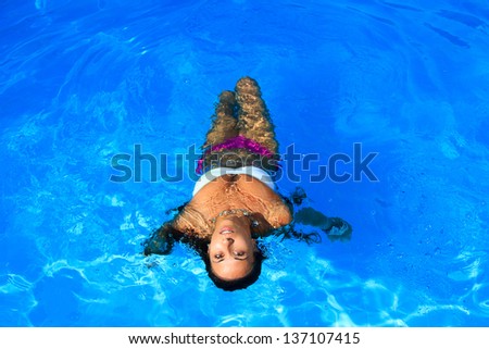 Young woman relaxing in the water. Summer.