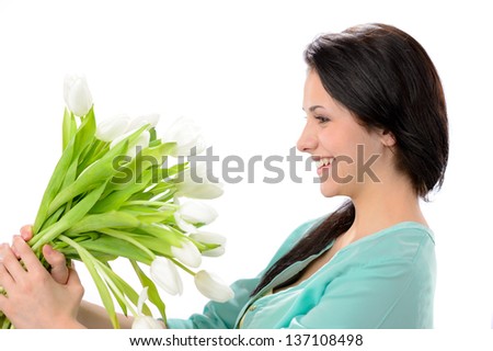 Elated young woman with bouquet of white flowers