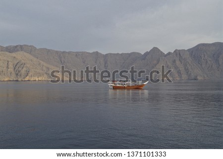 Picture of a traditional wooden boat utilized for short cruises in cristal waters between cliffs. Tourists and divers paradise.