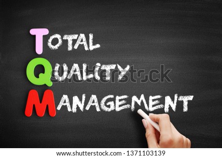 Color Wooden alphabets building the word TQM - Total Quality Management acronym on blackboard Royalty-Free Stock Photo #1371103139