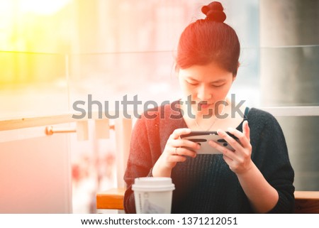Asian woman using smartphone in cafe shop