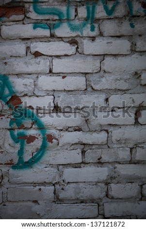 Whitw old brick wall with graffiti