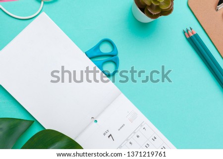 Top view flat lay of workspace desk styled design office supplies with calendar