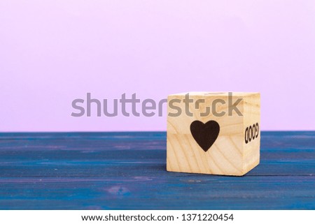 cube wooden block with heart drawn on it