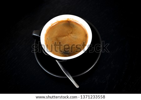 Cup of strong black coffe on wooden table