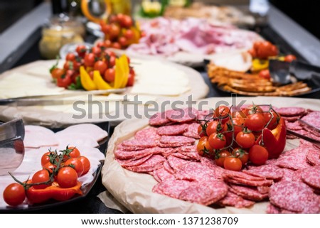 Selection of self service catering continental breakfast buffet display, catering or brunch table food buffet filled with all sorts of delicious food, meat platters in a hotel or restaurant setting