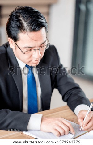 Man taking notes on a small books after business discussion