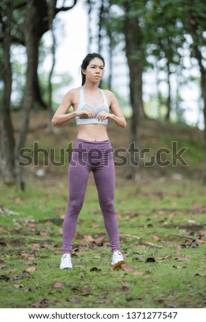 Young pretty slim fitness sporty woman doing stretching exercise during training workout outdoor at the park in the morning. Healthy lifestyle concept.