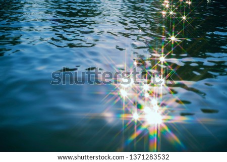 Abstract background from water texture with glitter from reflection of sunlight.
