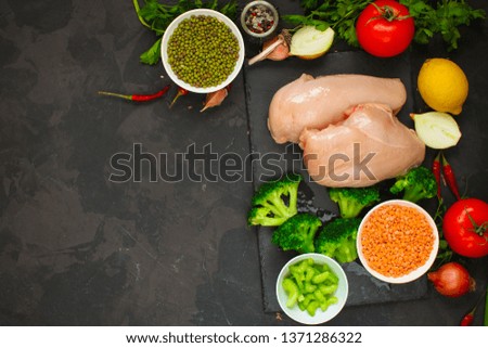 raw chicken meat, vegetables and legumes (lentils,  mung beans  and more) ingredients, healthy food. copy space. food background. top