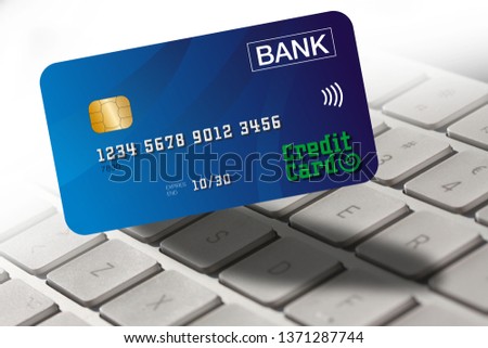 Credit card with computer keyboard in background. Close up home banking and online shopping concept stock photo.