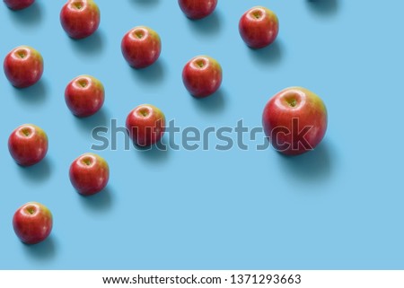 Juicy ripe red apples on a blue pastel background. Minimal concept. Top view Royalty-Free Stock Photo #1371293663