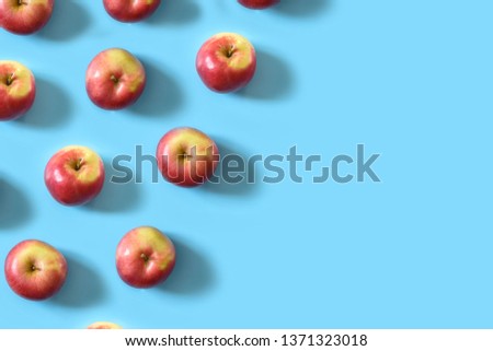 Juicy ripe red apples on a blue pastel background. Minimal concept. Top view Royalty-Free Stock Photo #1371323018