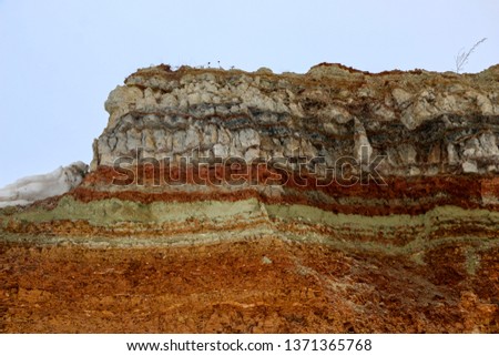 the texture of different layers of clay underground in a clay quarry after geological study of the soil.