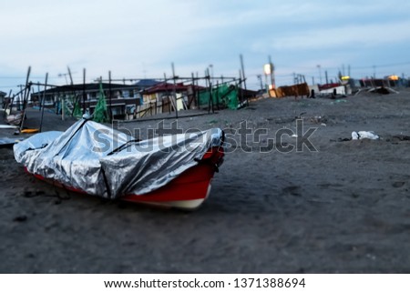 Picture of the red fishing boat in the beach.