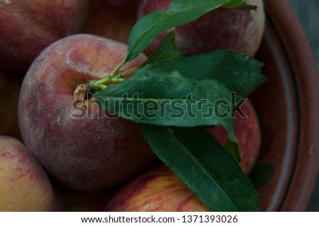 peach in a plate on a wooden table