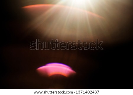 Light over black background. Easy to add overlay or screen filter over photos. Abstract sun burst with digital lens flare background.