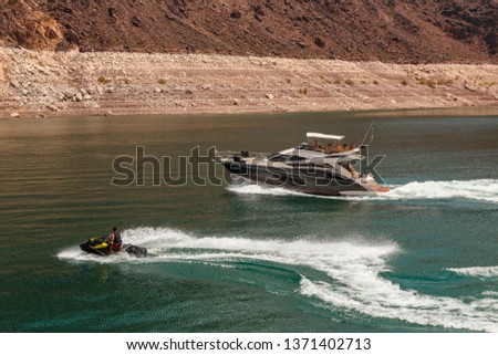 Landscape of Lake Mead with boat and water scooter on high speed Royalty-Free Stock Photo #1371402713