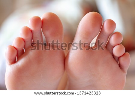 young girl's toes are healthy and beautiful. Well-groomed toes. Concept for medical articles and ointments - the image of the toes and feet. Image of legs with space for inscriptions and advertising. Royalty-Free Stock Photo #1371423323