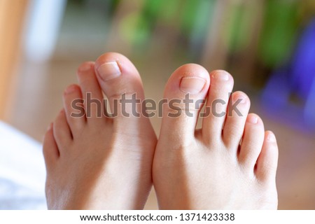 young girl's toes are healthy and beautiful. Well-groomed toes. Concept for medical articles and ointments - the image of the toes and feet. Image of legs with space for inscriptions and advertising. Royalty-Free Stock Photo #1371423338