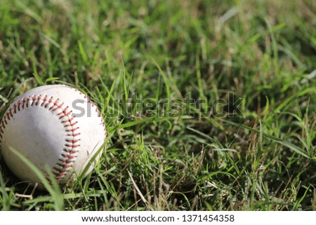 old baseball on green grass 
