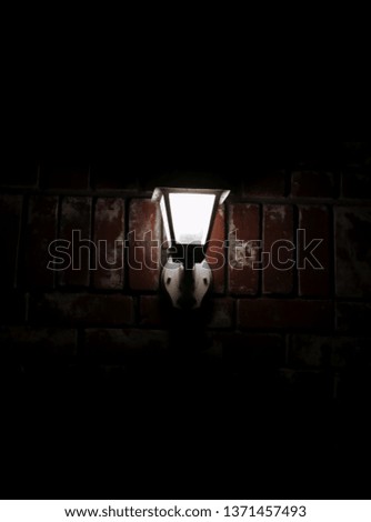 lamp lighting up the brick surrounded in darkness