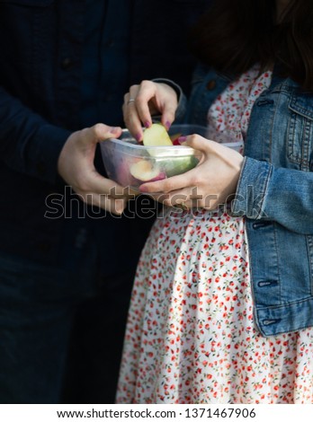 Pregnant woman and husband eating fruits. Healthy life Royalty-Free Stock Photo #1371467906