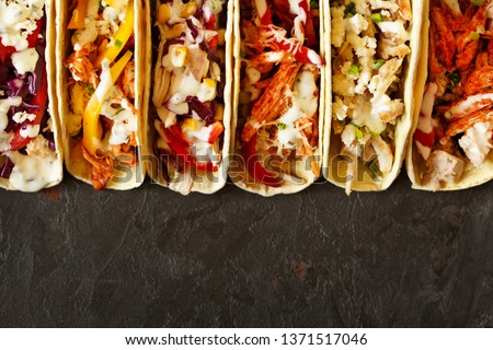 Mexican street food. Varied traditional mexican corn tacos flat lay composition.