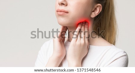 Woman with thyroid gland problem, touching her neck, closeup, panorama Royalty-Free Stock Photo #1371548546