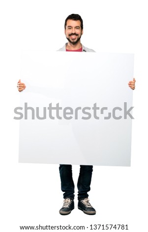 Full-length shot of Handsome man with beard holding an empty placard over isolated white background