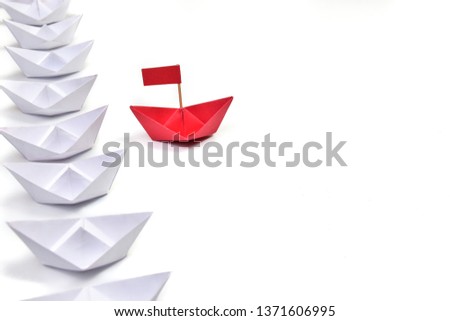 Leadership Red color paper with group isolated on white background. Boat paper origami view.