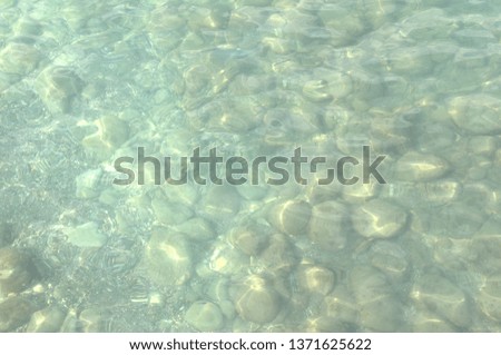 Large sea rocks with the water at the beach. The image close up
