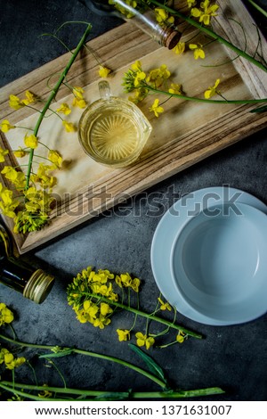 Rapeseed oil with flowers. Place for text.
