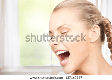 bright closeup picture of unhappy screaming woman