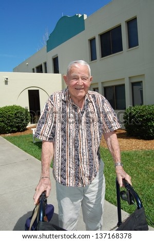Elderly man outside assisted living center.