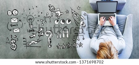 Business strategy ideas with man using a laptop in a modern gray chair
