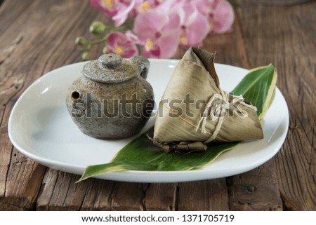 Zongzi - Traditional Dragon Boat Festival dumpling isolated on wood background