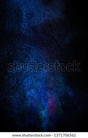  Multi-color powder explosion on black background.