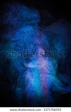   Multi-color powder explosion on black background.