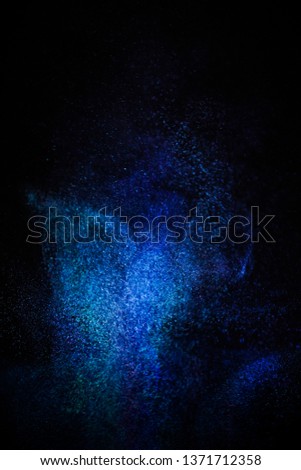   Multi-color powder explosion on black background